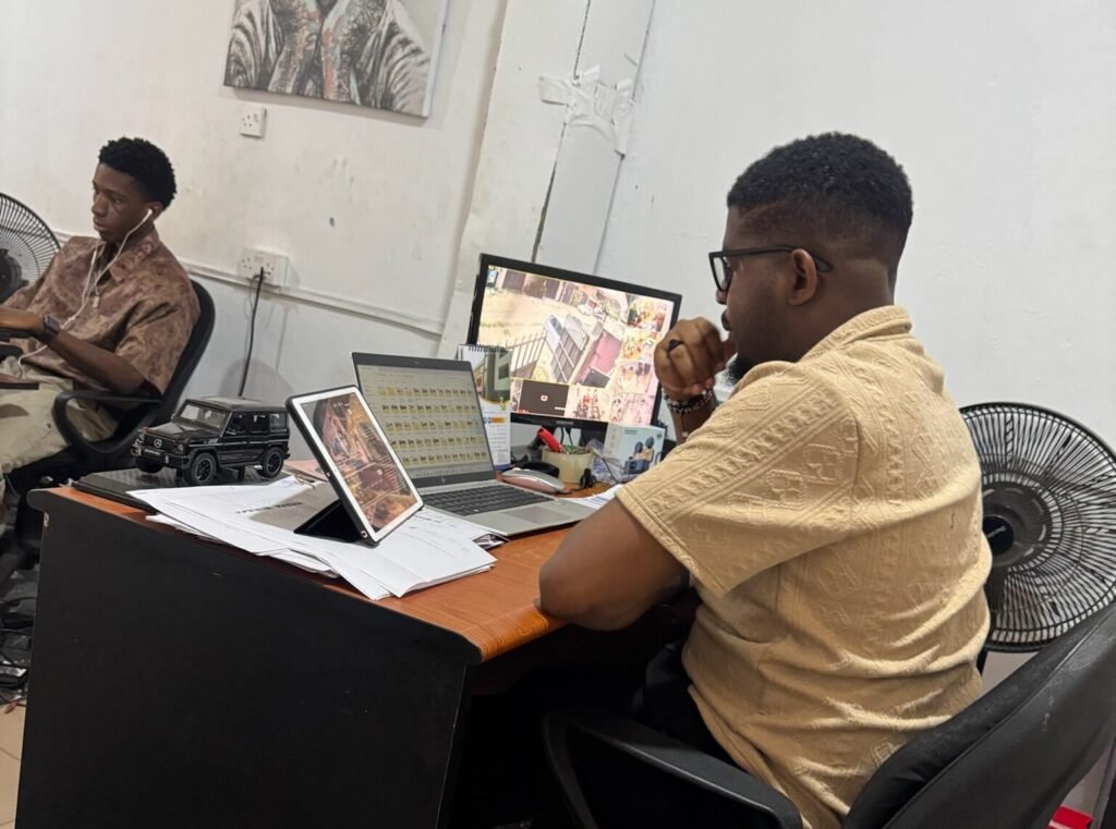 Ejike reviewing marketplace information on a laptop at his desk